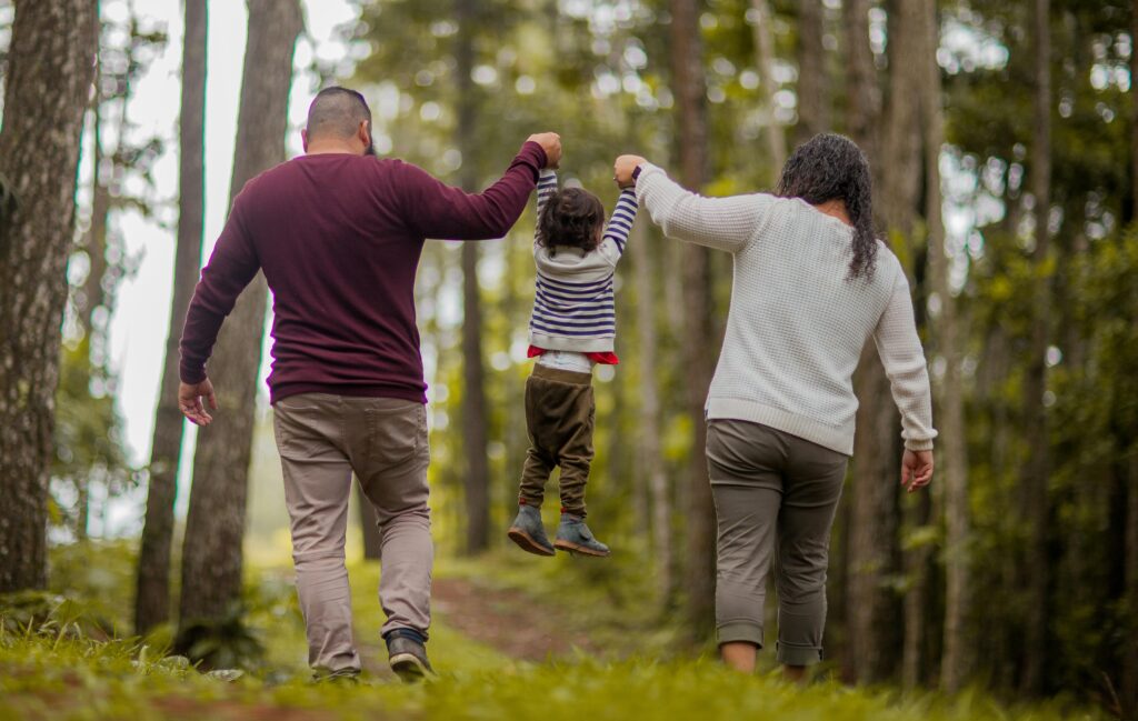 mother and father lifting up the child 